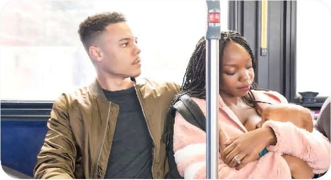 Parents comfort their baby while seated on a train.