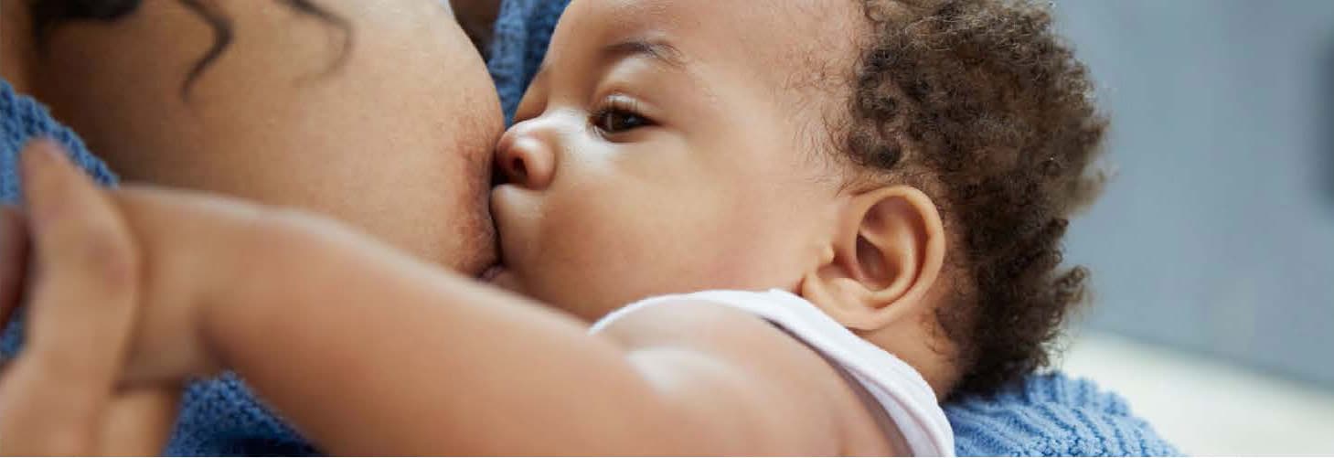 A baby latches to breastfeed.