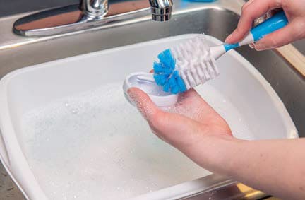 Use a scrub brush to clean all surfaces.