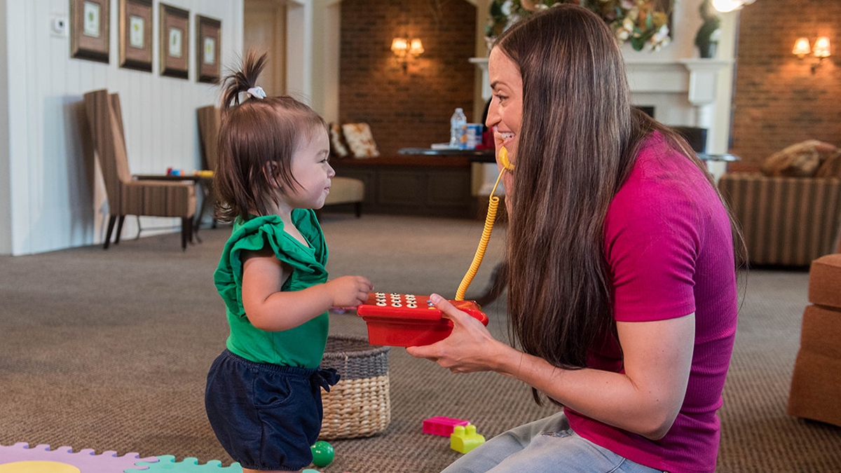 mom and daughter playing with play phone