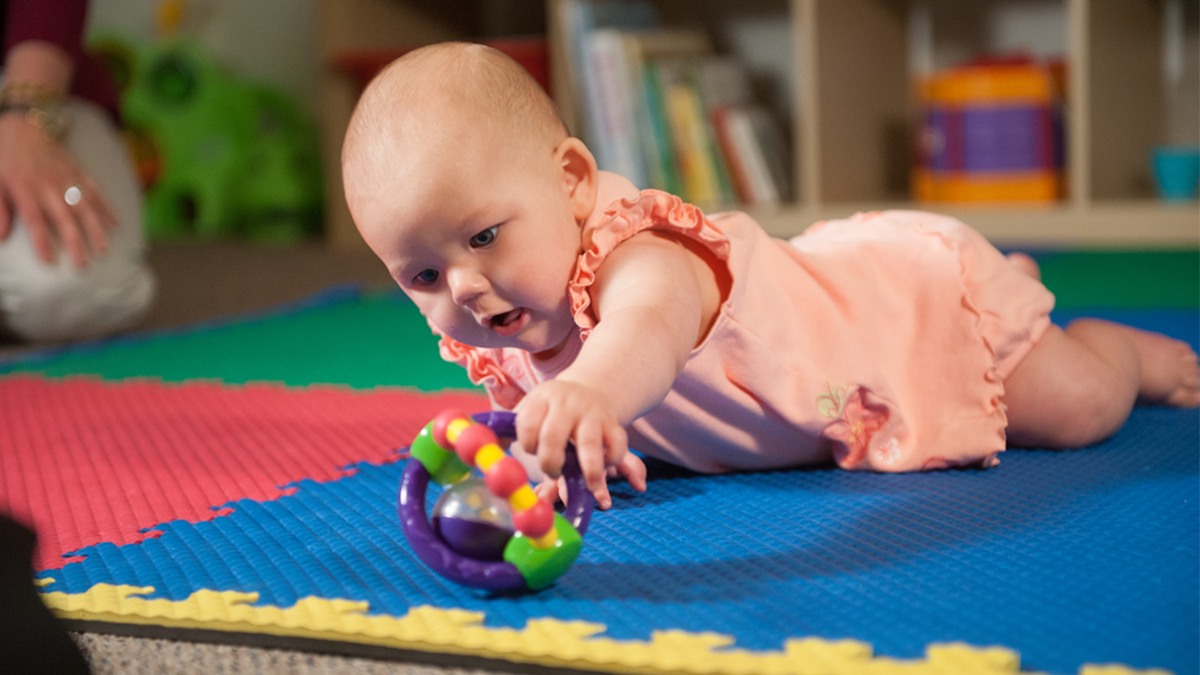 baby grabbing for a toy
