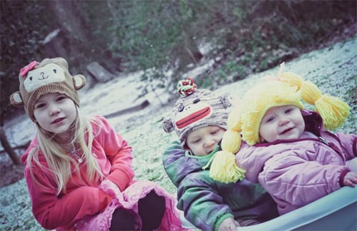 Savannah, Caden, and Kylie play in the snow after they arrived home.