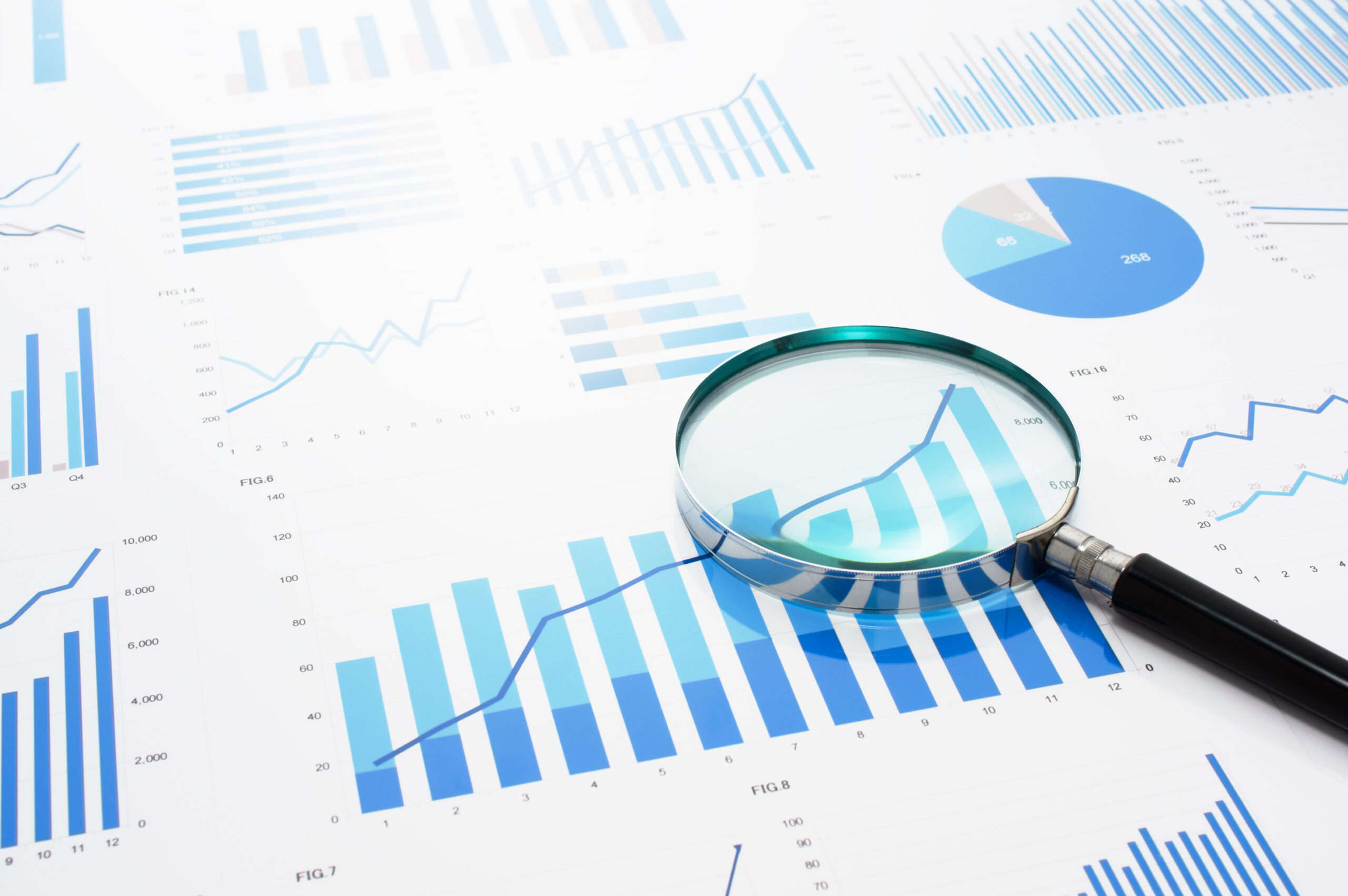 Magnifying glass laying on top of bar graph