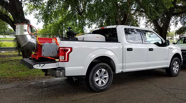 Pickup truck set up with an insecticide sprayer