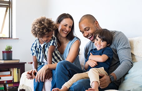 mom, dad, and two kids on couch