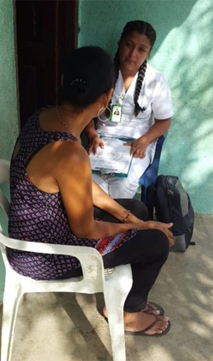 Woman is interviewed by a health care worker in Columbia.