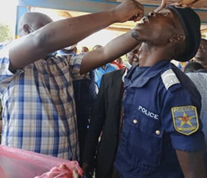 A police officer receives oral cholera vaccine during a campaign in Democratic Republic of the Congo, 2021.