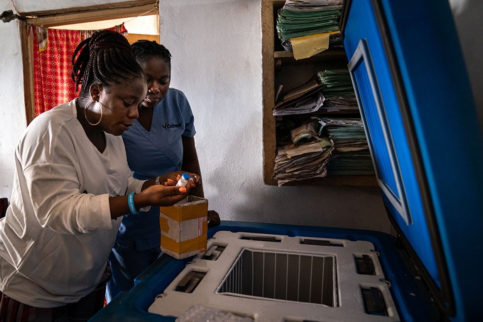 Health workers checking vaccines in the storage refrigerator at a health center in Democratic Republic of the Congo (DRC).