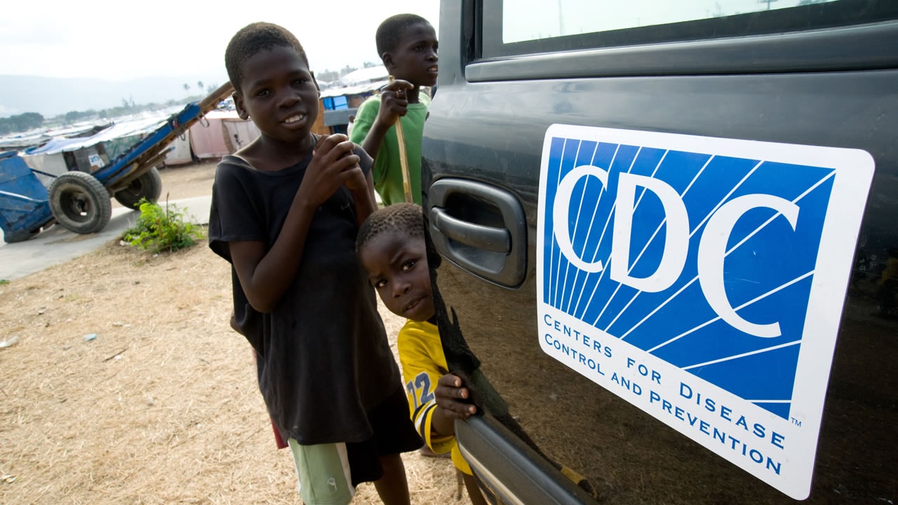 Young boys gather around a CDC truck.