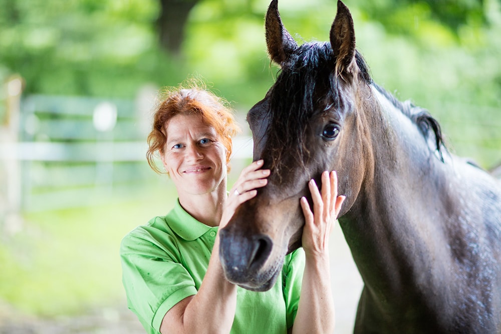 Veterinarian smiling with horse