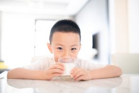 Asian boy drinking milk