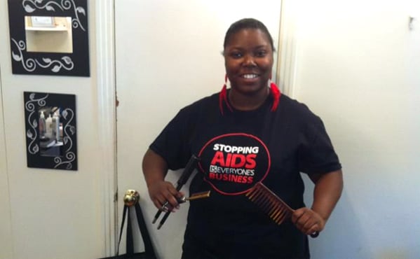 CDC Hairstylist/Barber HIV Prevention Initiative partner, Jenesta Rogers (Nashville, TN), wears a Stopping AIDS Is Everyone’s Business T-shirt to promote “HIV ShopTalk” discussions during Divine Interventions Beauty Emporium’s HIV Awareness Day