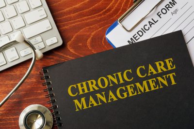 Book with title chronic care management on a table.