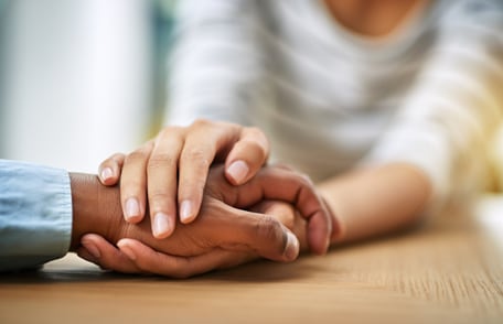Image of hands, showing one person comforting another