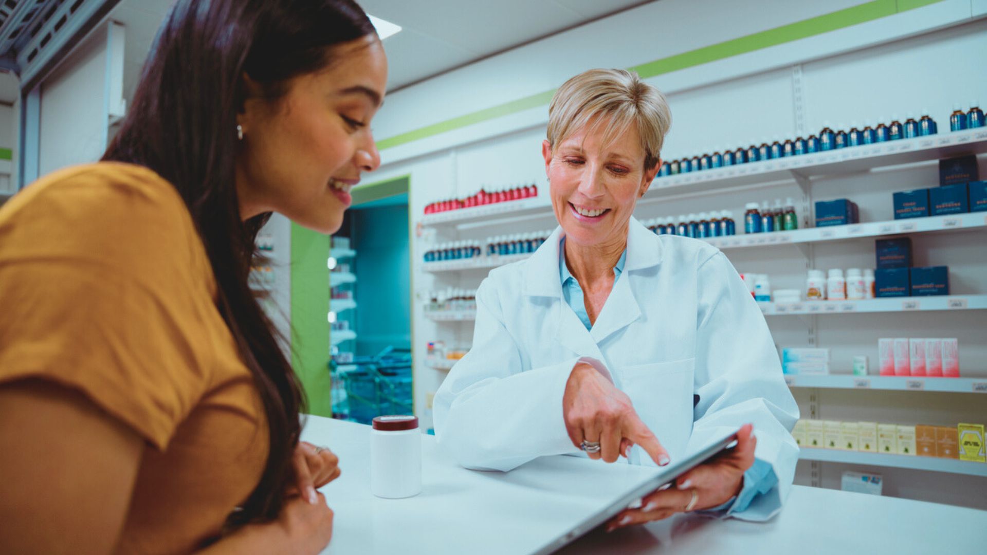 Woman talking with pharmacist about medications