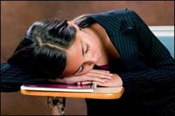 The figure above is a photograph showing an adolescent girl asleep on her desk.