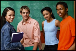 The figure above is a photograph of a four teenagers standing in front of a chalkboard.