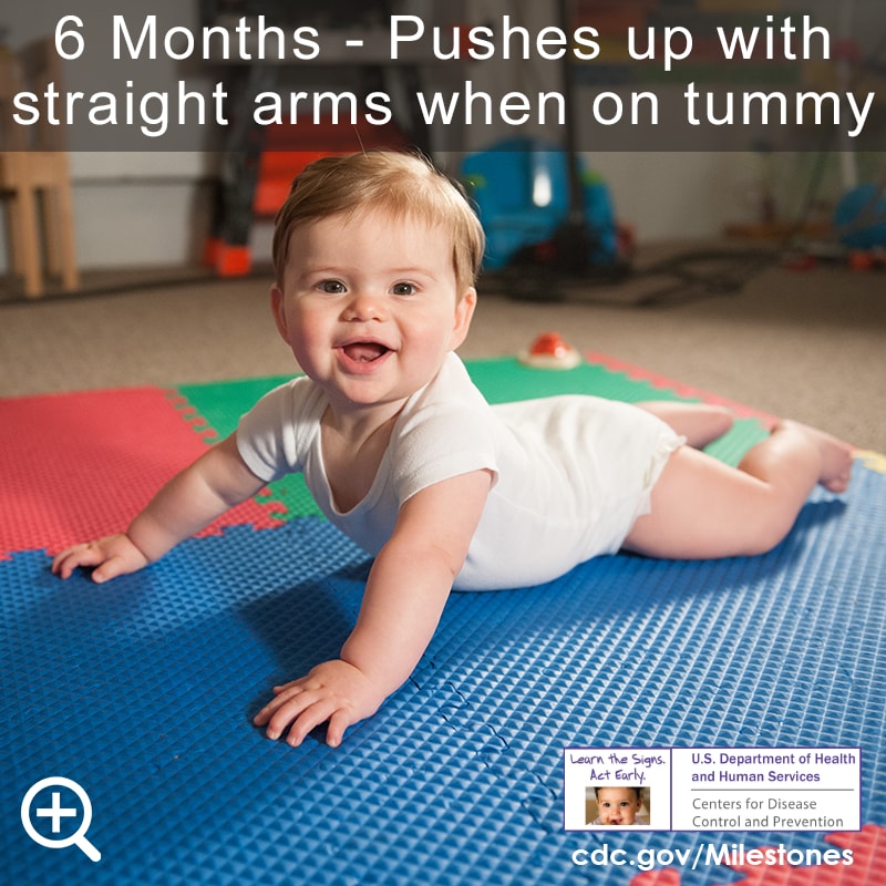 Pushes up with straight arms when on tummy