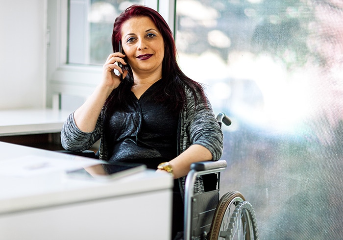Woman in a wheelchair talking on a cell phone