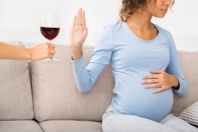 Pregnant woman refusing wine