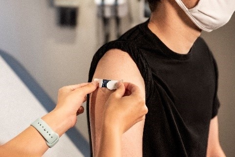 Man receiving a vaccine in his arm