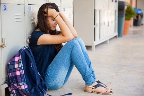 A teen girl upset at school