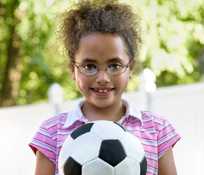 A girl holding a soccer ball