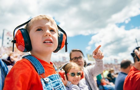 A child wearing hearing protection at an air show.