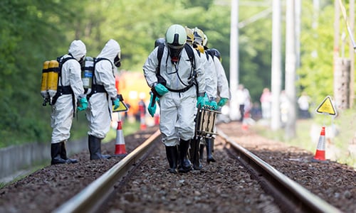 Toxic chemicals emergency team working on a railroad track