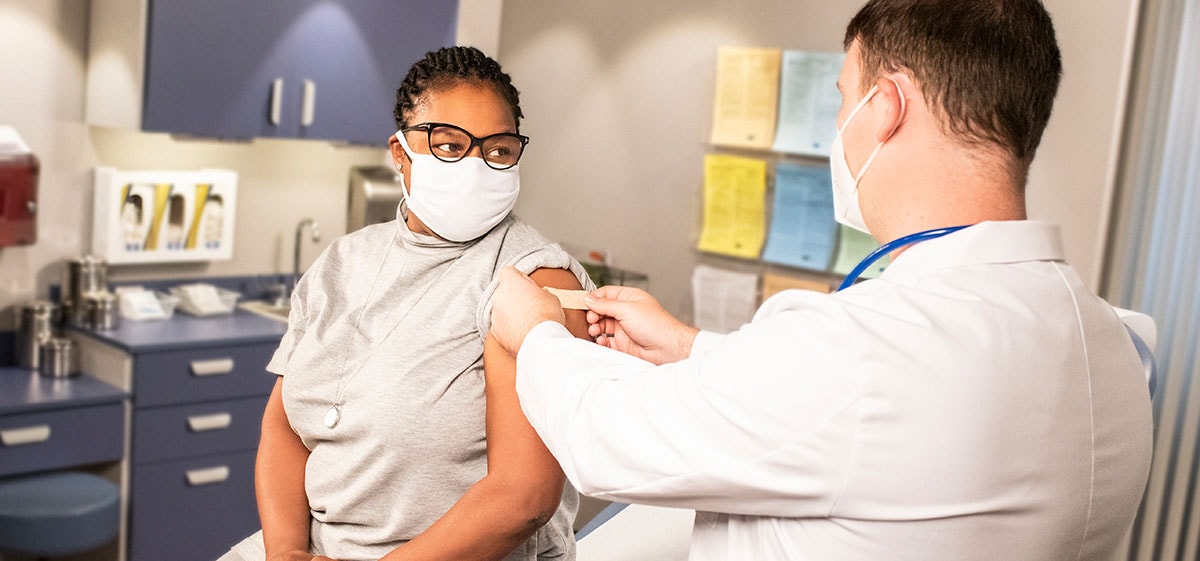 Patient receiving vaccine from heathcare worker