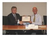 Dr. Richard Fenske receiving the Director’s Award plaque from NIOSH Director John Howard, M.D.