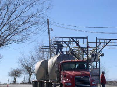 tanker truck accessing tank lid from catwalk