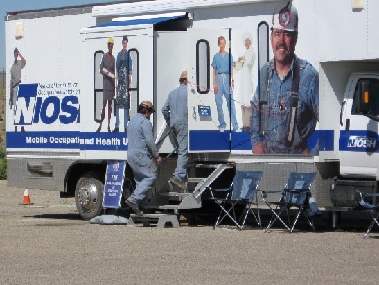 Miners entering a mobile screening vehicle