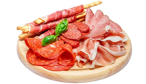 Cold smoked meat plate with pork chops, prosciutto, salami and bread sticks