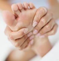 Woman massaging her foot