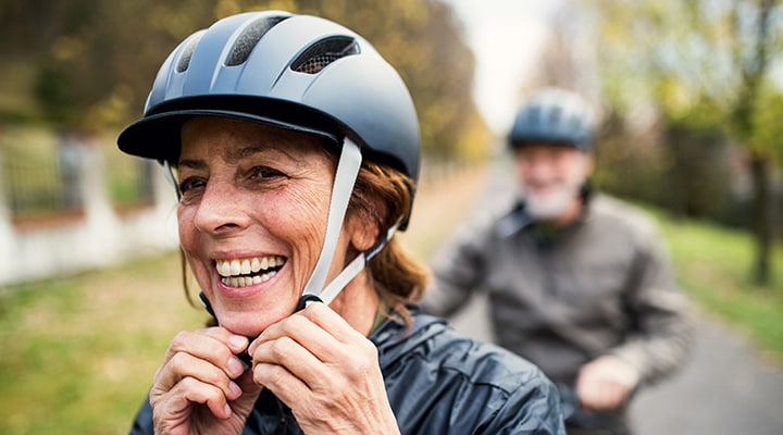 Woman adjusting her bike helmet