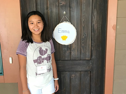Emma smiling in front of a door.