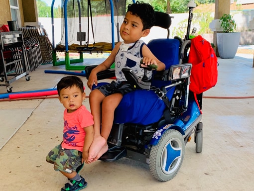 Francico in his powerchair with his little brother.