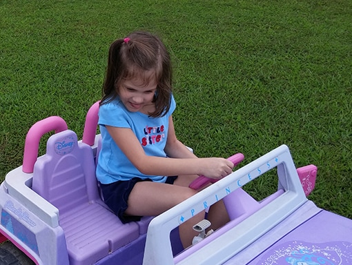 Kinley playing in her toy car. 