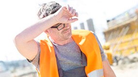 Construction worker wiping off sweat