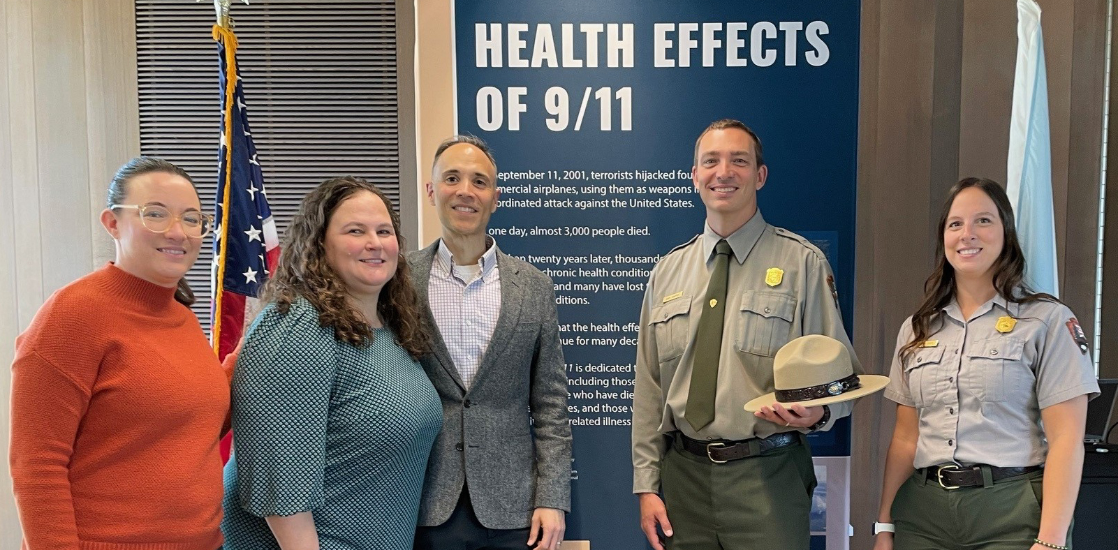 WTC Health Program and Flight 93 Memorial staff standing together at the exhibition.
