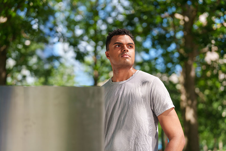 Bejan, a member who enrolled though young adult outreach standing at the 9/11 memorial.