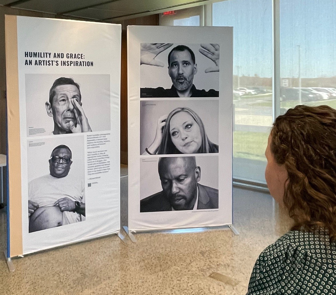 Exhibition panels showing large black-and-white portraits of responders and survivors. 