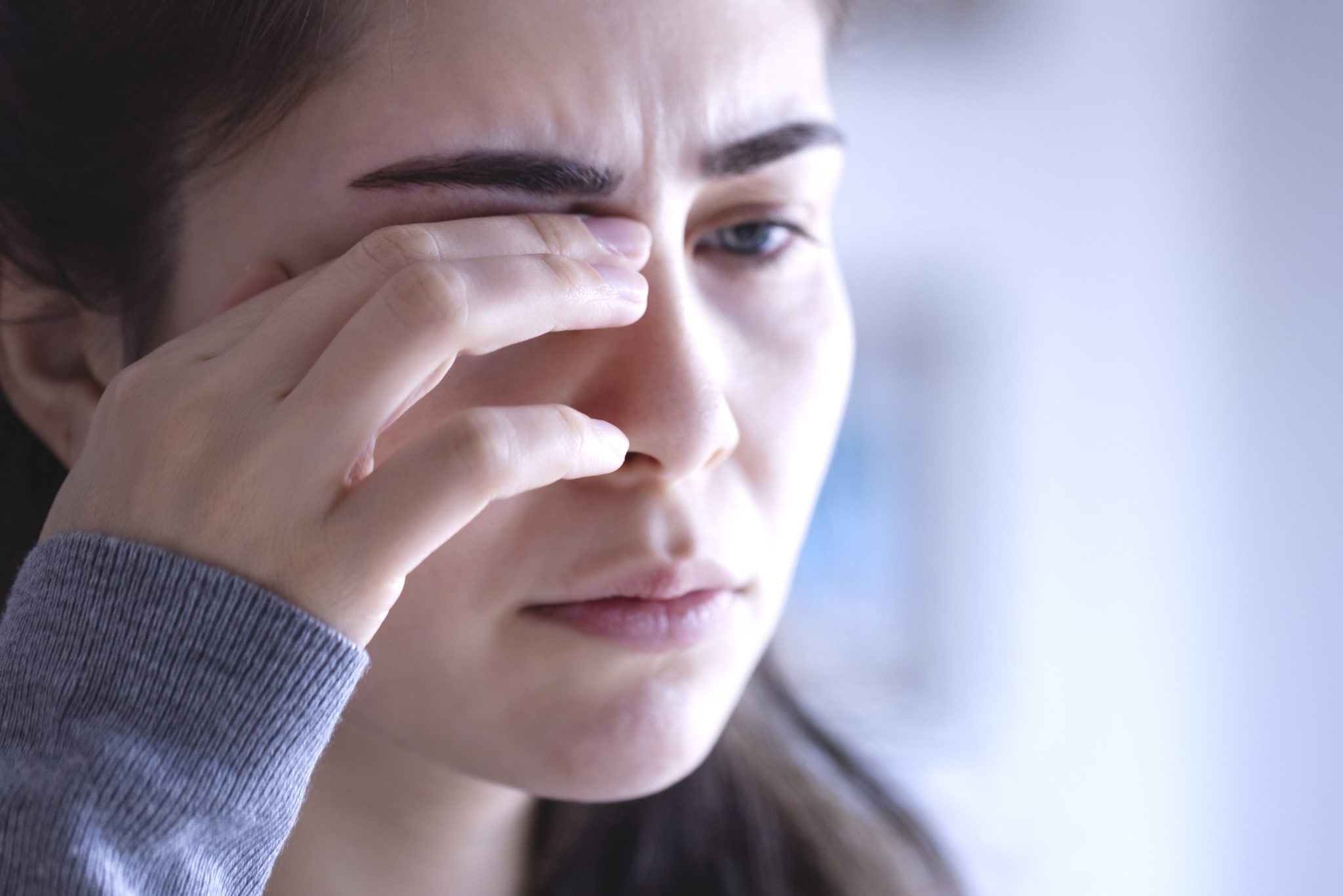 Woman rubbing her eye