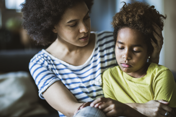 Adult woman comforting a young child