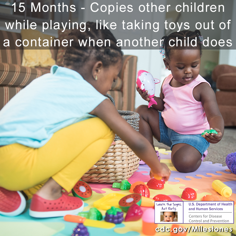 Copies other children while playing, like taking toys out of a container when another child does image 2