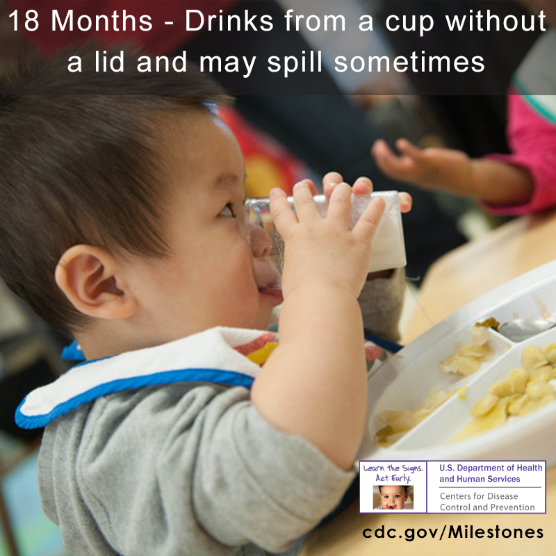 The child in this photo is holding a cup and drinking it without a lid.