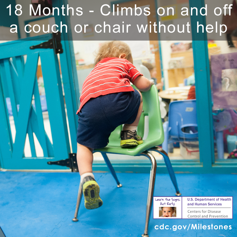 The child in this photo is wearing a red shirt and stepping onto a green chair without help, an 18 month milestone.