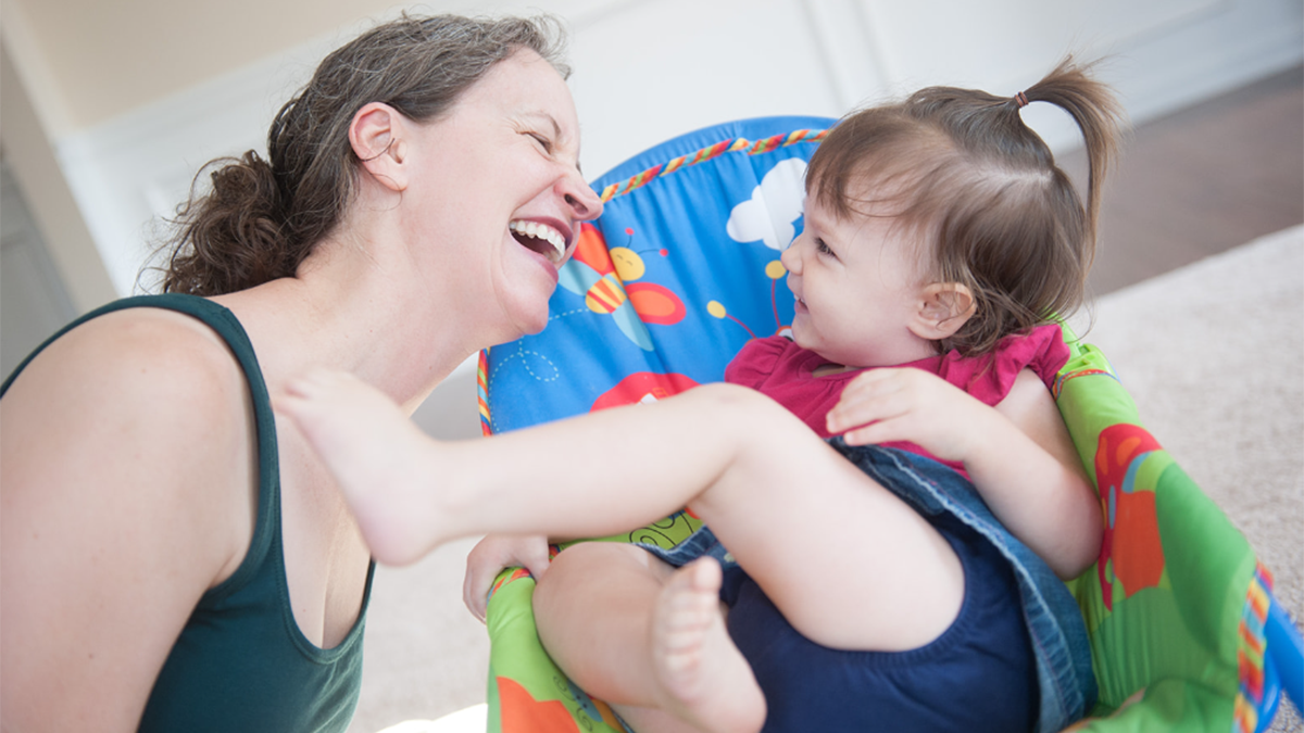 Mom and daughter smile at each other.
