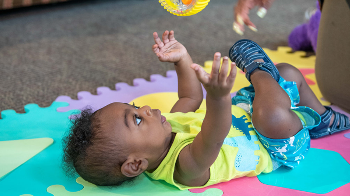 Baby swinging at toy